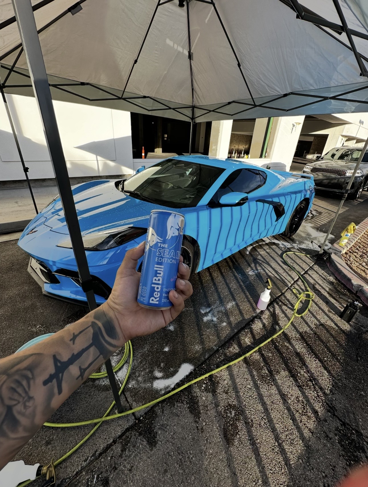 Milkyway Detailz team detailing a blue Corvette in Las Vegas